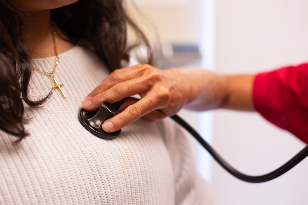 Close up of a provider placing a stethoscope on a patient's chest