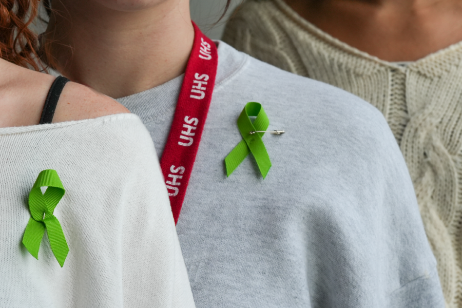 Students wear green suicide prevention ribbons
