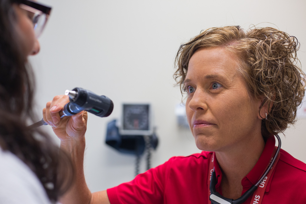 A provider examines a student
