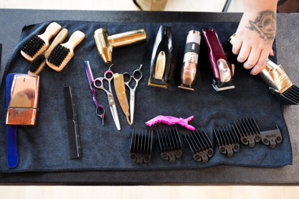 Barber tools placed on a black towel at Barbershop Talks in 2024