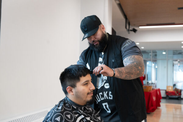 Barber cutting a students hair
