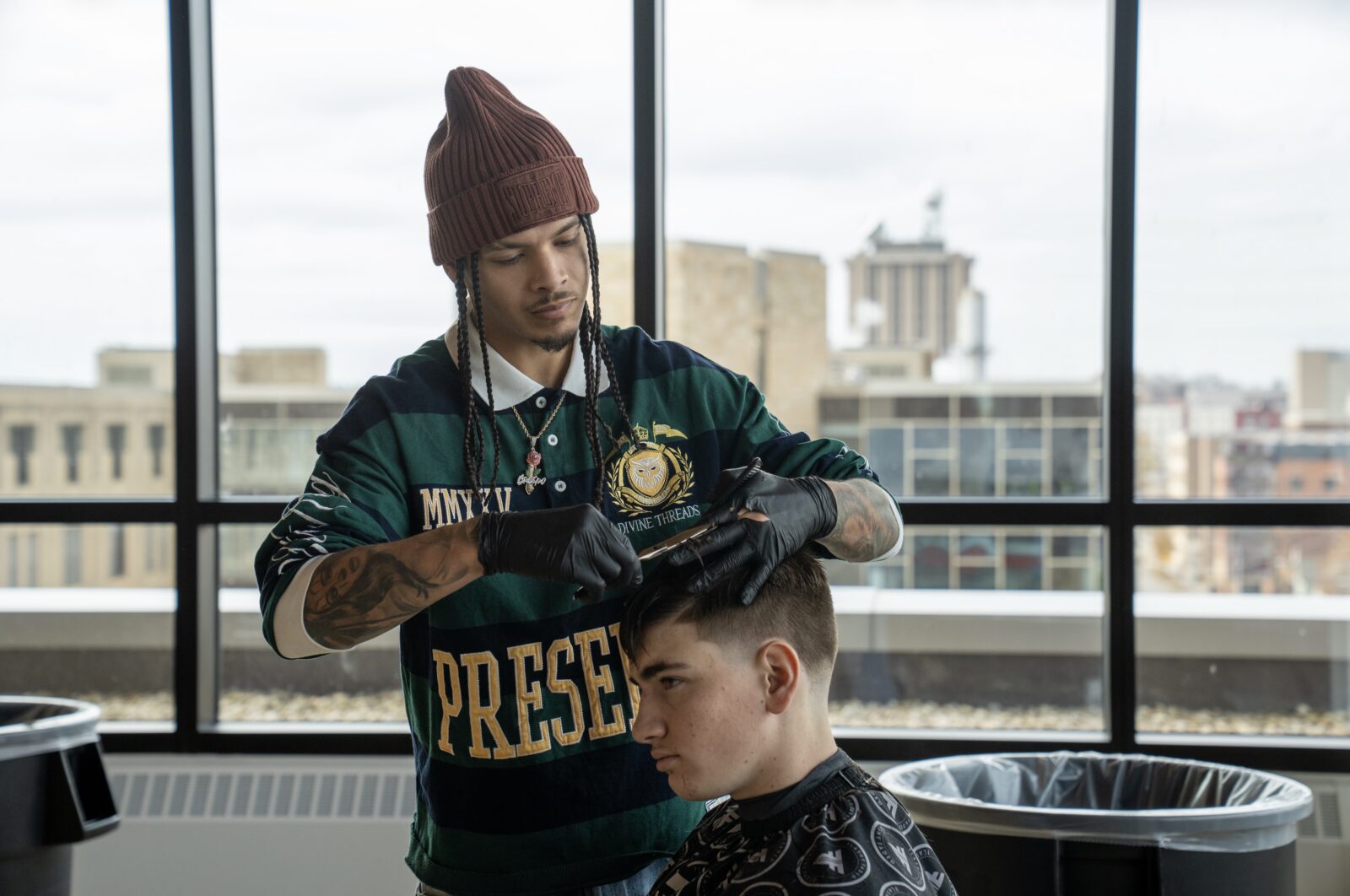 Barber cutting students hair.
