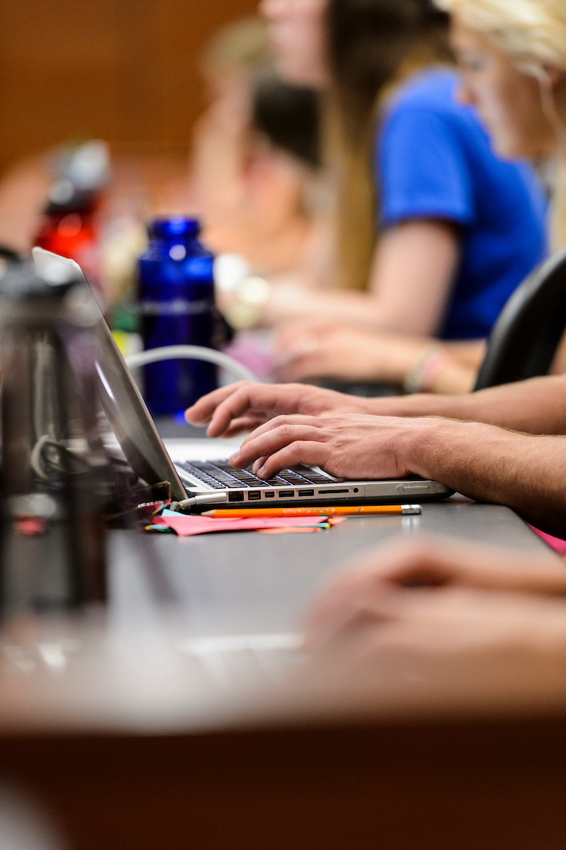 Closeup of hands typing on a laptop
