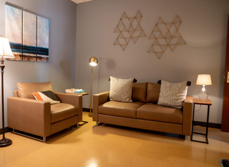 Sexual Assault Forensic Exam room located on the 7th floor of UHS featuring a couch and chair.