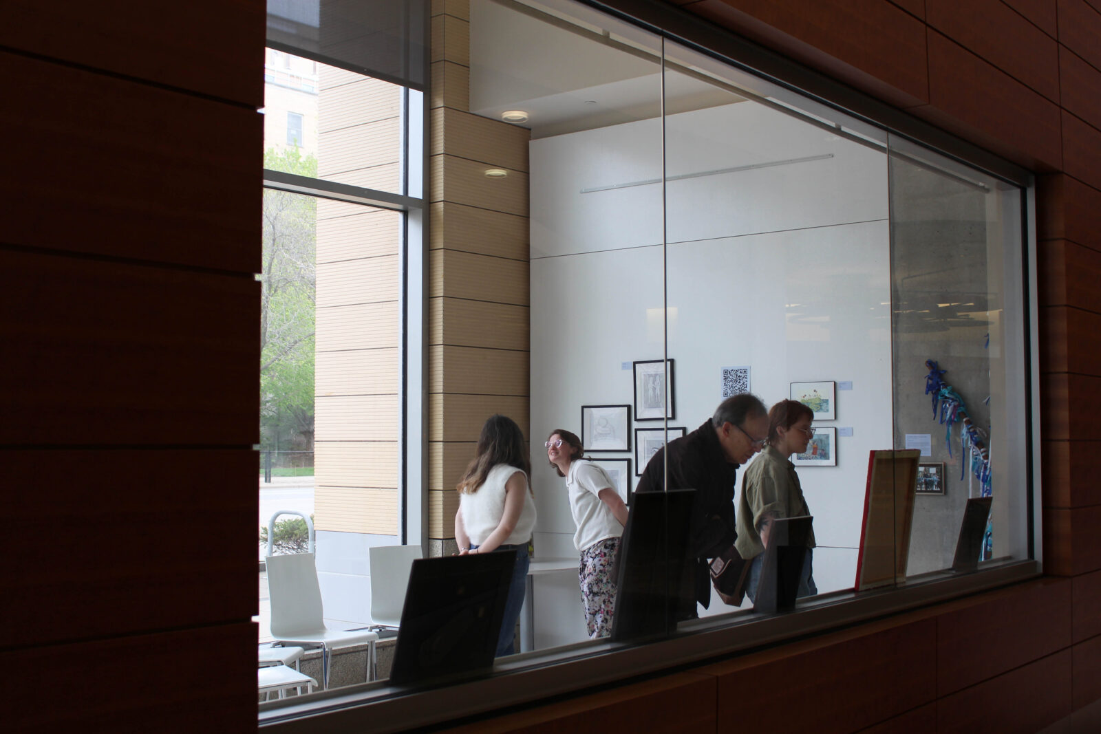 Attendees view the student survivor art at the closing reception in Discovery Hall