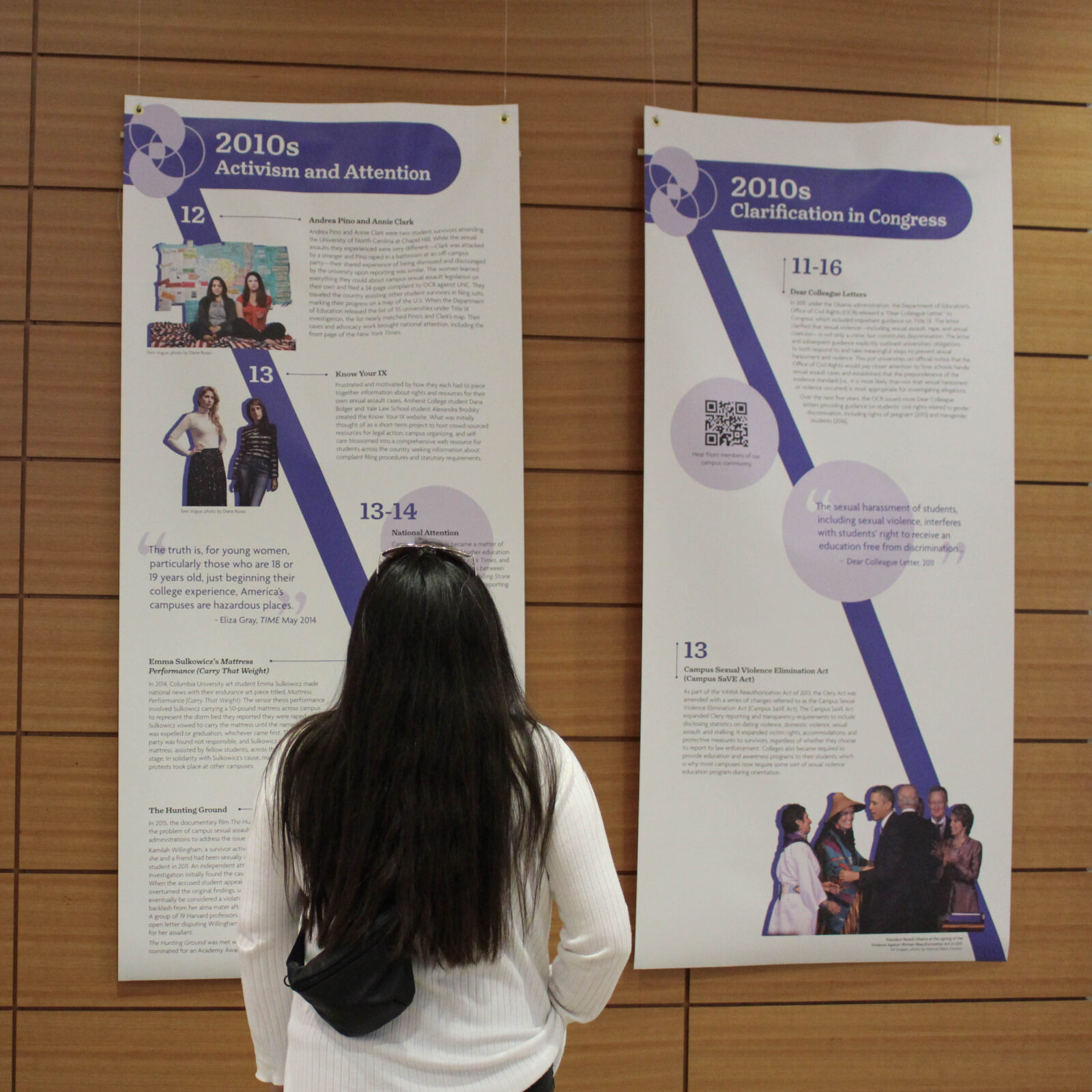 Student views Sexual Assault Awareness Month history banners at the closing reception in Discovery Hall