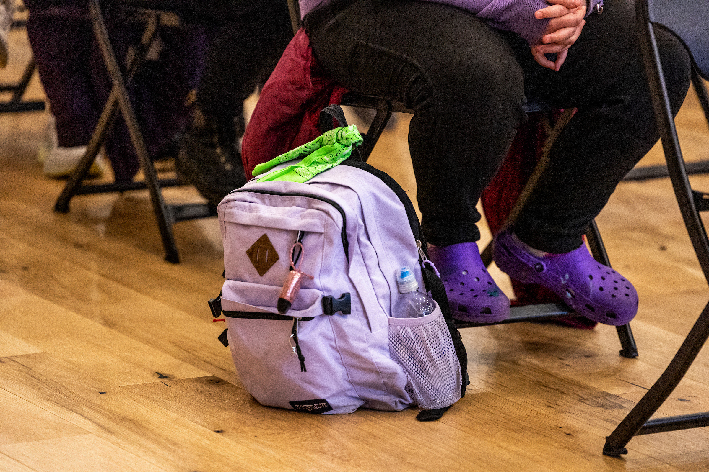 A student with a green bandana tied to their backpack, indicating mental health acceptance