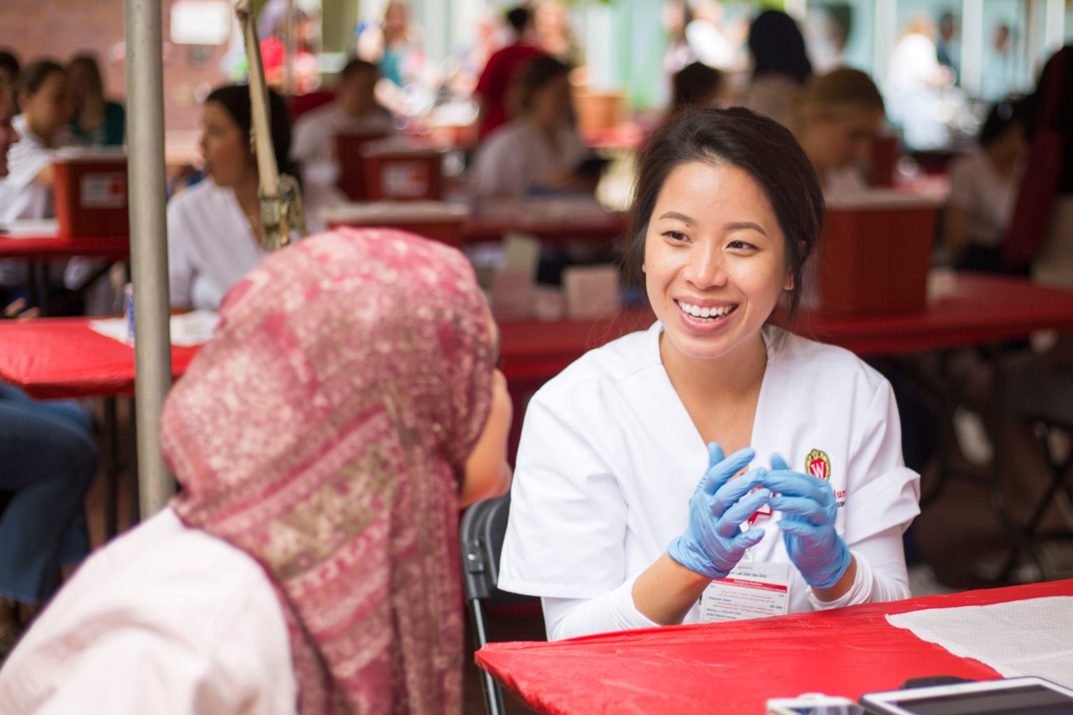 A provider speaks to a person receiving a vaccine at a UHS vaccine clinc